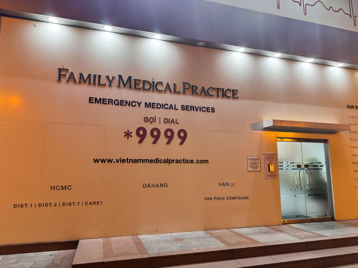 Wall sign reading Family Medical Practice, Emergency Medical Services, Dial *9999.