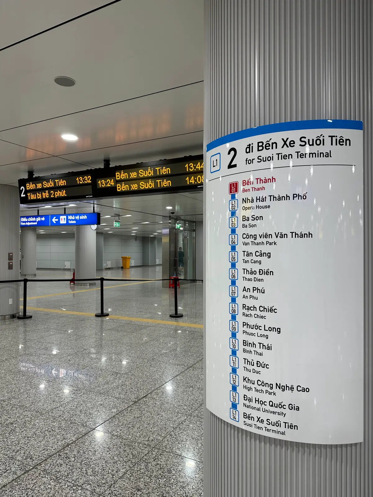 Blue and white line map board listing every station name, next to a platform display
