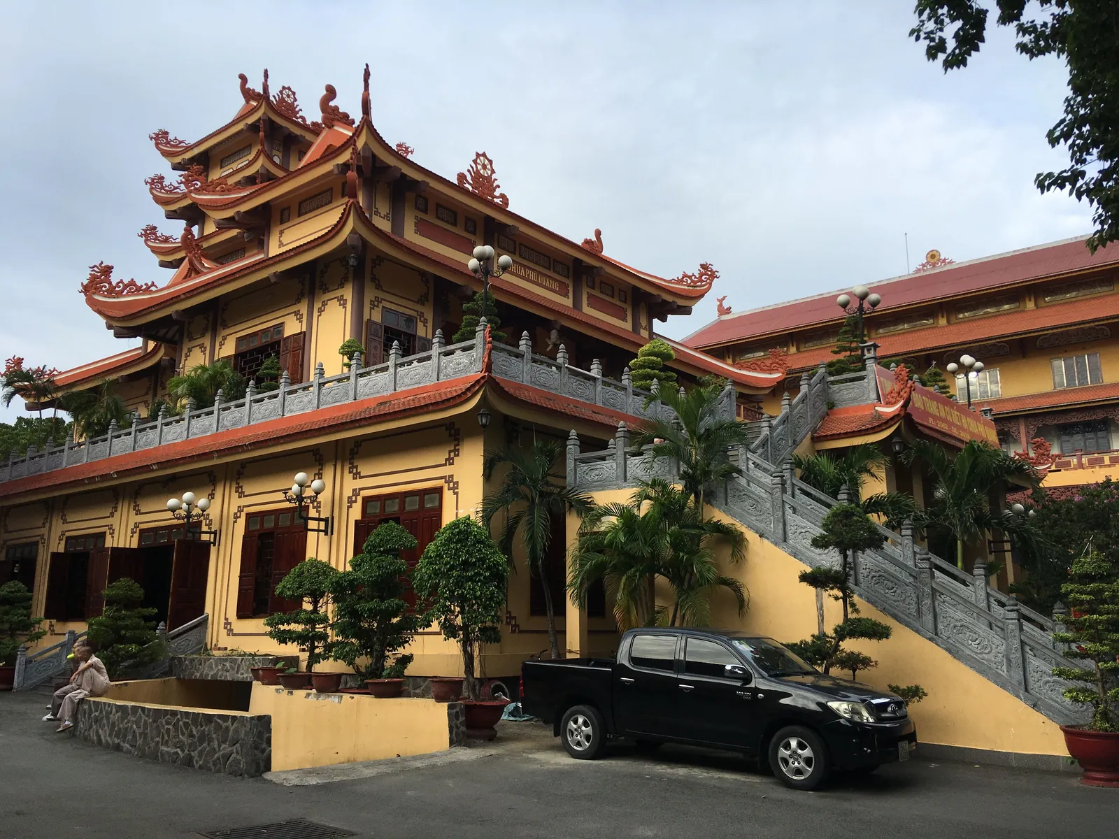 Two-storey pagoda with golden walls and red tiled roofs