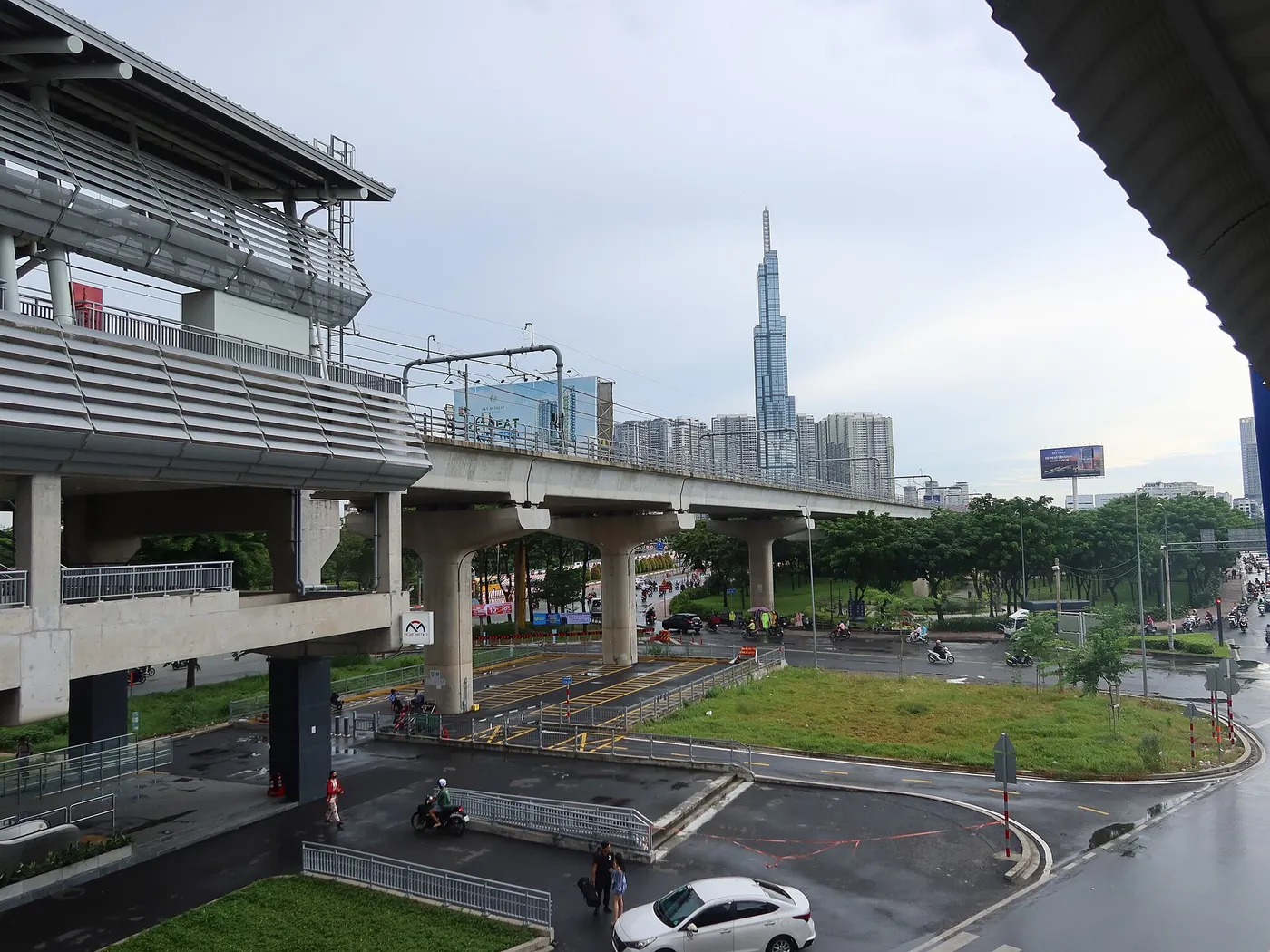 Elevated metro station and tracks in Thao Dien with a tall tower in the distance